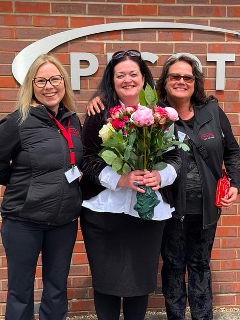 katja, dawn and jutta with flowers celebrationg dawn being voted trenchless woman of the year